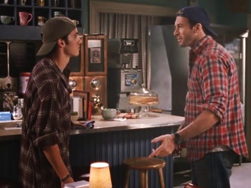 Jess cosplays as Luke in a flannel shirt and backwards baseball cap